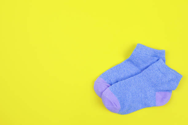 istock Pair of children's socks on a yellow background 1463178211