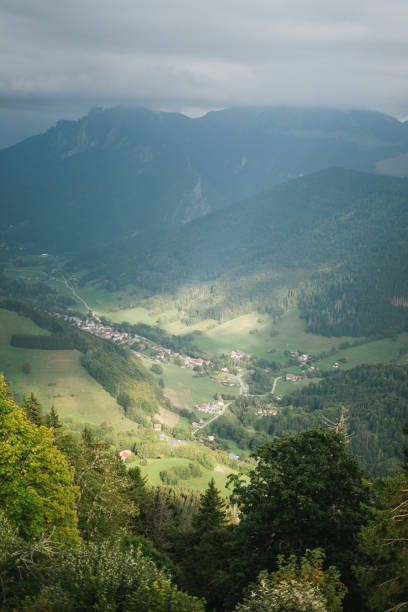 istock Majestic mountains in the Alps covered with trees and clouds 1463184317