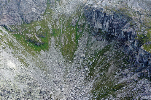 Huge rocks in the swiss alps. The image shows a mountain range in the swiss alps at an altitude of 2'200m in the canton of glarus, captured during summer season.