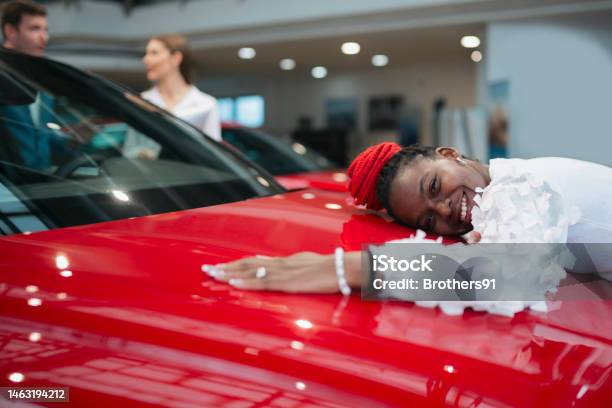 Happy Young Woman Giving Her New Car A Big Hug Stock Photo - Download Image Now - Humor, Car, Car Dealership