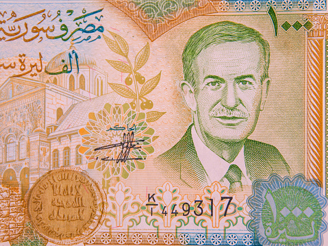 Depiction of former President of Syria, Hafez Al-Assad, on a 1,000 lira banknote of the Syrian Arab Republic.  Prior to the civil war starting in 2011, this was worth about US$30, in February 2023 it is worth less than $US2.