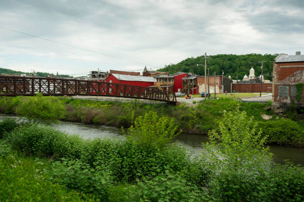 istock Old iron foot bridge leading to town 1463210356