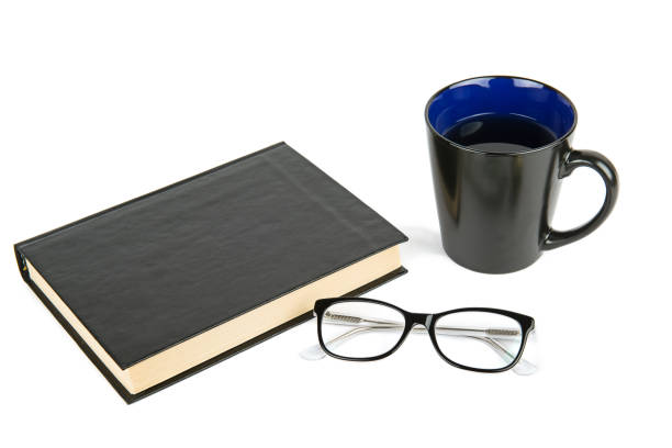 istock Book, glasses and coffee cup isolated on white . 1463215257