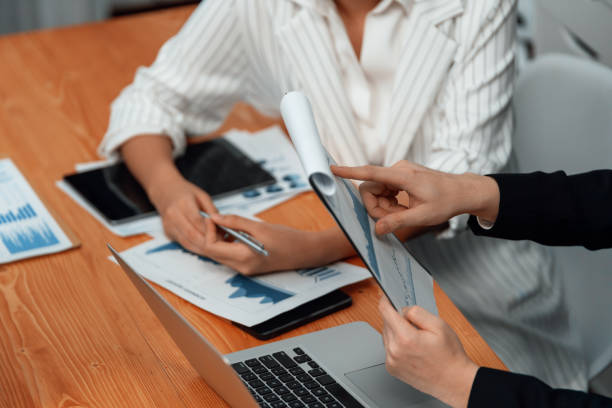 istock Office worker and manager analyze financial report paper in harmony workplace. 1463218525