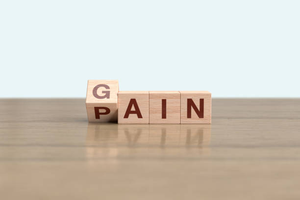 istock Wooden block cube flipping PAIN to GAIN 1463224246