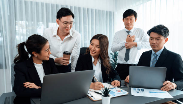 istock Office worker and manager analyze financial report paper in harmony workplace. 1463229054