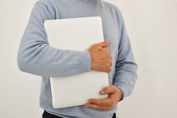 istock Adult man holding laptop computer isolated on white background. Copy space. 1463230360