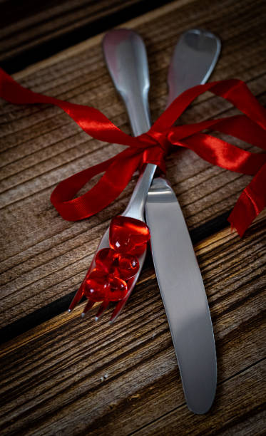 istock Glass hearts with a fork and a knife on the table. 1463232461