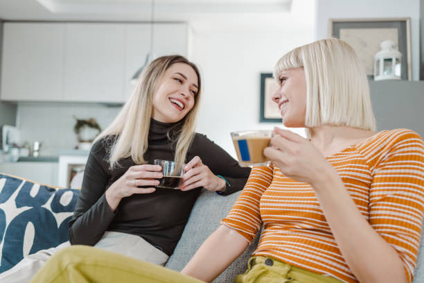 istock Female friends talking and drinking coffee at home 1463236777