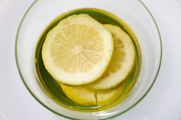istock overhead view of lemon drink with fruit slices inside on wooden table 1463238125
