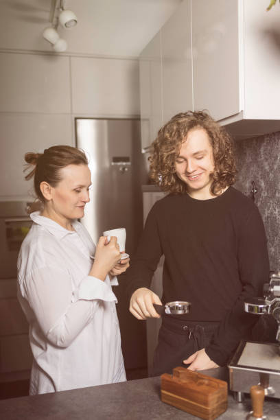 istock Mum having fun with son making coffee in the kitchen 1463239989