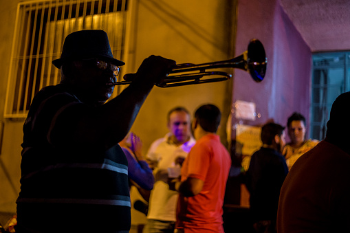 Cuiabá, Mato Grosso, Brasil - february, 5, 2016 - reveler playing trumpet and enjoying carnival in brazil