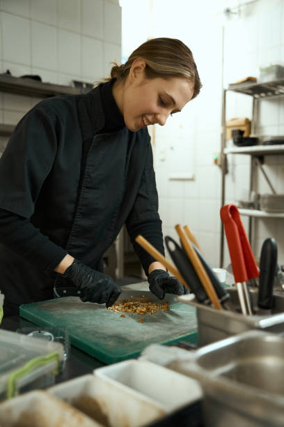 istock Young female chef grinds nuts on a cutting board 1463250672