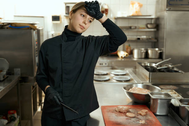 istock Tired chef stands at the cutting table with a knife 1463251058