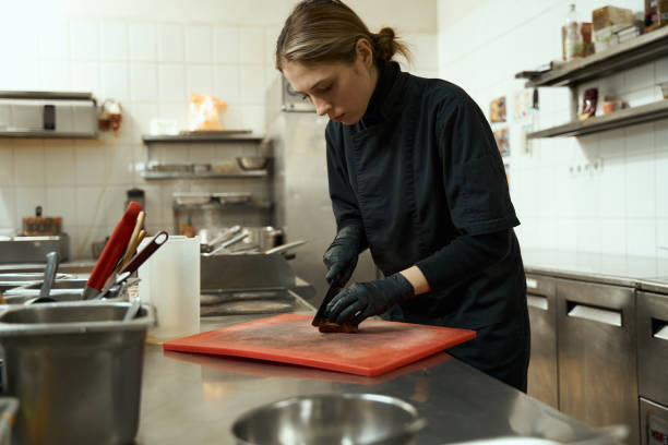 istock Woman cuts meat on a cutting board 1463251622