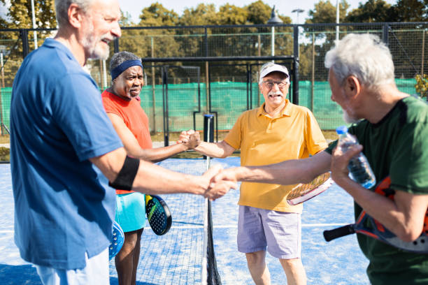 istock Four seniors shaking hands before starting their padel play in doubles 1463251994