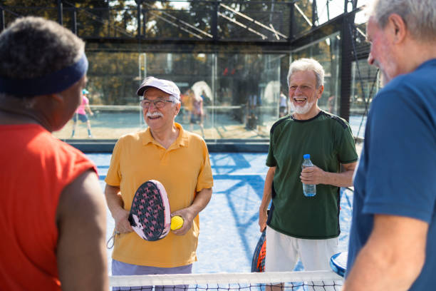 istock Four cheerful seniors taking a break while playing padel 1463251998