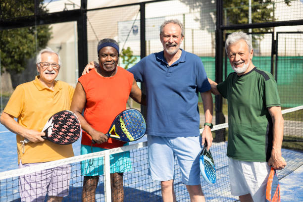 istock Senior friends having fun playing padel 1463252041
