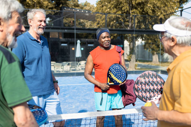 istock Four cheerful seniors taking a break while playing padel 1463252053