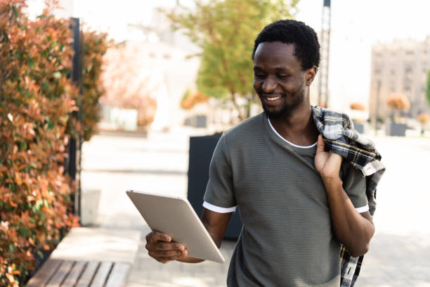 istock Portrait of a young African walking and using tablet 1463252097
