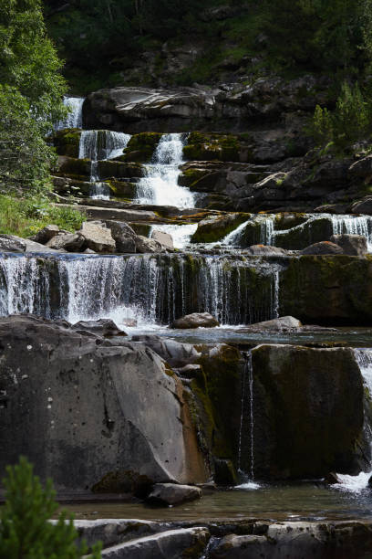 istock Waterfall in a landscape of rocks and vegetation 1463252975