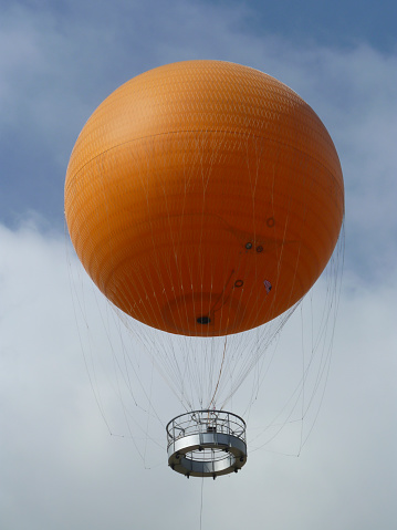 In May 2012, the Orange Balloon, a local landmark in Irvine, California, floats 400 feet (122 meters) above the town.  Its permanent tether is visible below the basket.