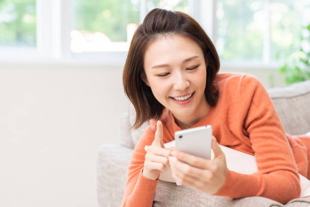 istock attractive Asian woman using a smart phone 1463256060