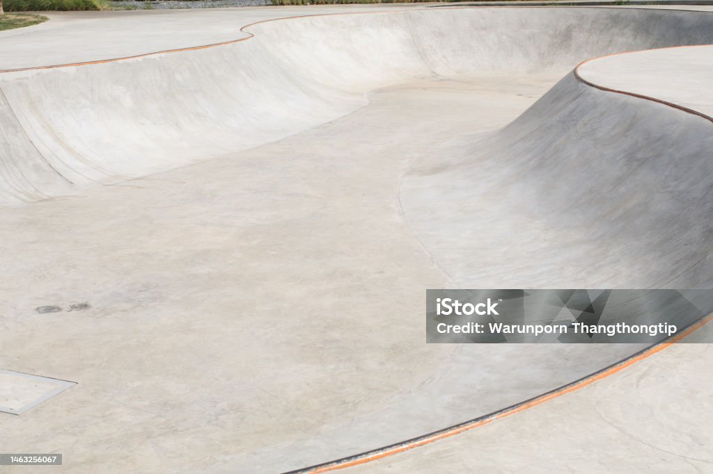 Concrete skatepark  with Tubes and Jumps at public park. sports near the house. ramp for extreme athletes. Skating Stock Photo