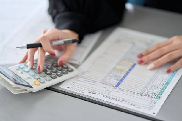 istock Asian woman preparing tax return documents 1463258350