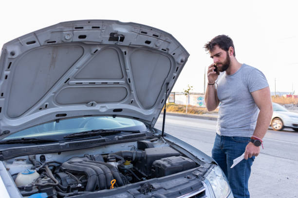 young man having car engine problems on the road calling asking for help to car insurance