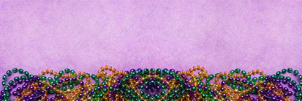 istock Mardi Gras Beads On A Purple Background 1463259626
