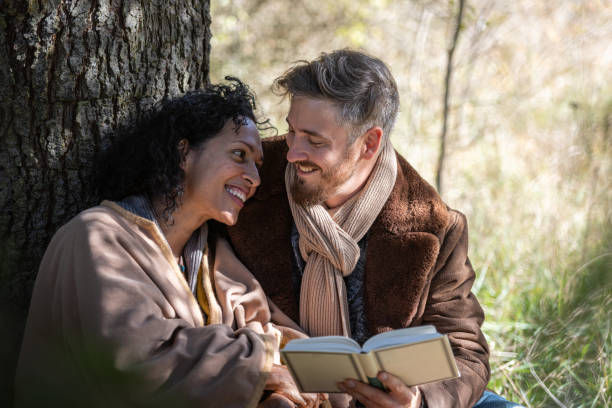 istock A romantic date of lovers under the tree. 1463260275