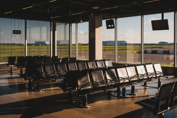 istock empty airport lounge with runway view windows 1463270880
