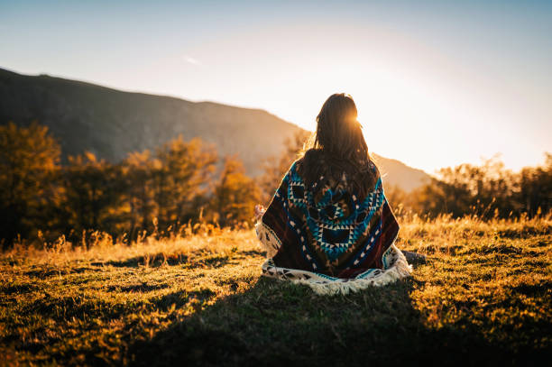 Embrace the moment! Young boho woman in the nature. Young woman watching the sunrise and meditating in the nature. aborigine woman stock pictures, royalty-free photos & images