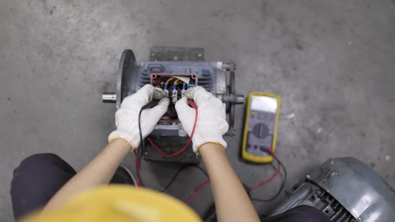 A young engineer is using a multimeter to check the winding resistance in a motor.