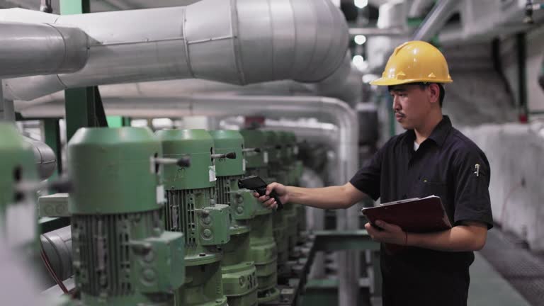 A technician is using a laser temperature gun to monitor the temperature of the motor and record the measured value.