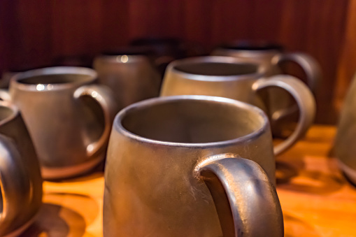 Many dark gray coffee cups, mugs