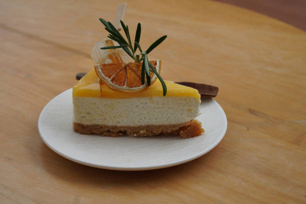 istock closeup fresh honeyslice, dry orange slice, green leaf on yuzu cheese pie on white ceramic plate on wooden table background, food, dessert, health, copy space 1463293000