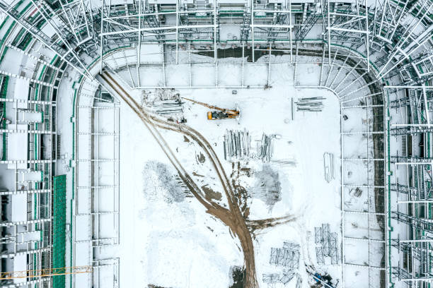 istock new stadium under construction. construction site with crane in winter time. aerial top view. 1463293211