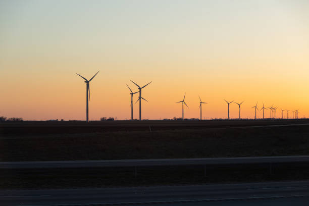 istock Wind turbines farm and highway road 1463294858