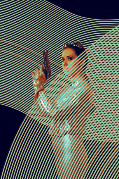 Spy Holding a Gun in Light-painting Artistic Poster Style Imagery Long exposure portrait of an action superhero in futuristic outfit steampunk pistol pictures stock pictures, royalty-free photos & images