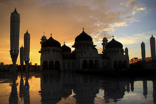 View of the splendor of the Baiturrahman Grand Mosque in Banda Aceh at night and at sunrise.