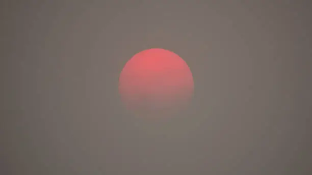 Photo of Red Sun in Thick Smoky Polluted Air