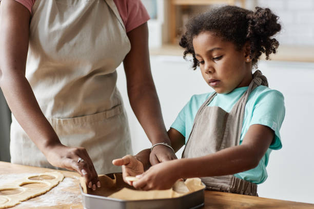 istock Little girl baking pie with mother 1463319554