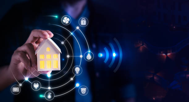 istock Man holding small home model with virtual display as assistant house remote control 1463325974