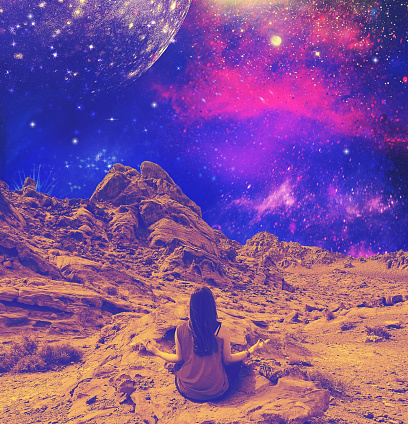 Surreal art collage or design. Abstract landscape with woman in yoga meditation with space color background and fire valley as background.