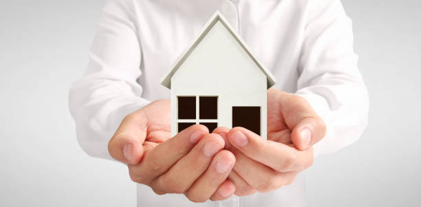 istock House Residential Structure in  hand ,business home idea 1463330615