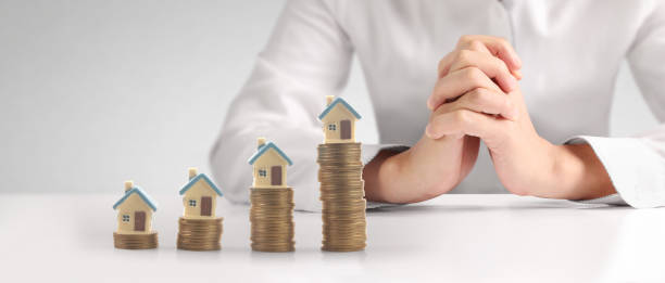 istock House Residential Structure in hand ,model house and coin 1463330631