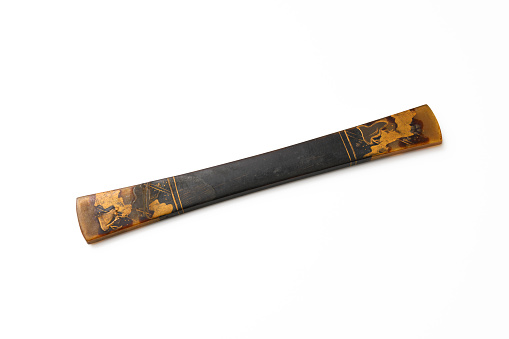 Close-up of antique Tortoise Shell Japanese Hairpin on white background.