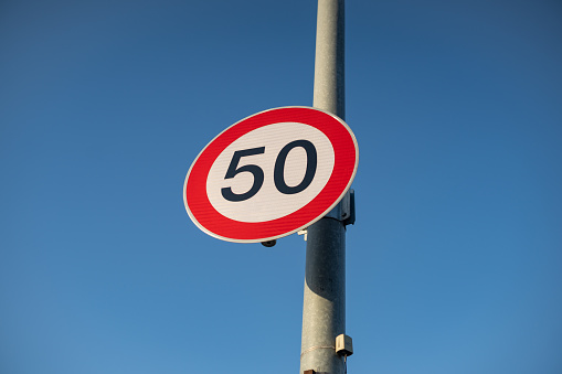 Seoul, South Korea - January, 2023: 50km/h speed limit sign with a blue sky background